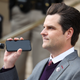 Rep. Matt Gaetz (R-Fla.) holds a phone to the microphone as Donald Trump Jr. speaks remotely to a crowd during a rally against Rep. Liz Cheney (R-WY) on January 28, 2021 in Cheyenne, Wyoming. Gaetz and Trump Jr. added their voices to a growing effort to vote Cheney out of office after she voted in favor of impeaching Donald Trump.